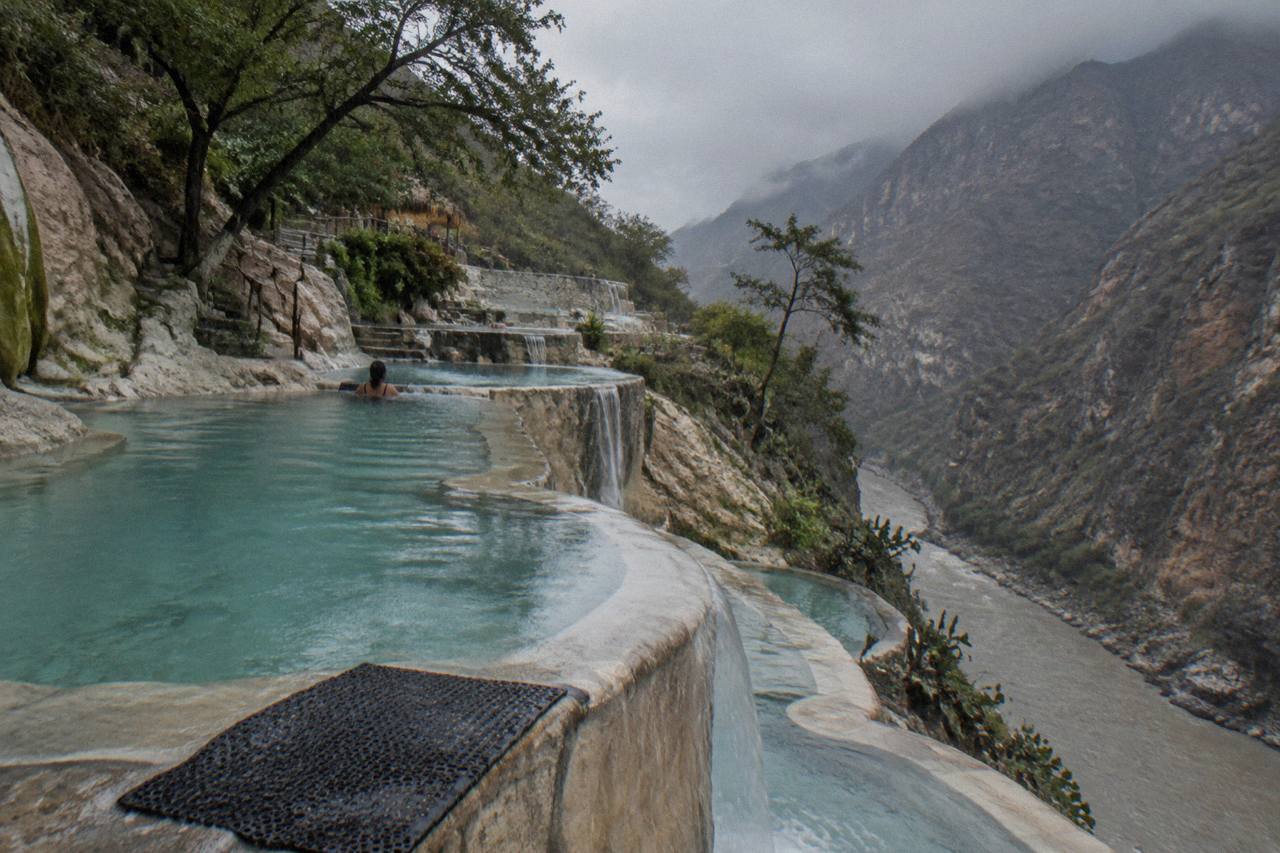 Thermal pools built into the canyon wall above the river at Grutas de Tolantongo