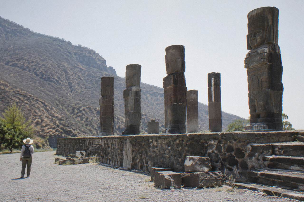 Stone columns and carved figures on an ancient pyramid platform