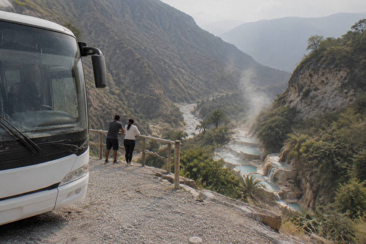 Tour coach parked at the canyon rim above the thermal pools at Tolantongo