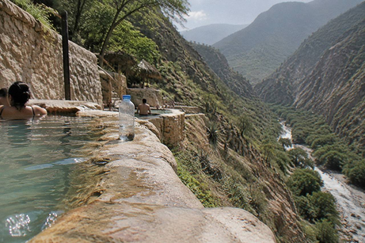Cliffside thermal pools overlooking the green canyon at Paraíso Escondido