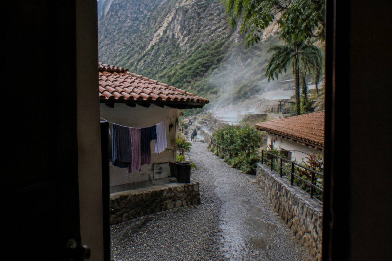 Simple rooms with tiled roofs along a hillside inside the canyon park