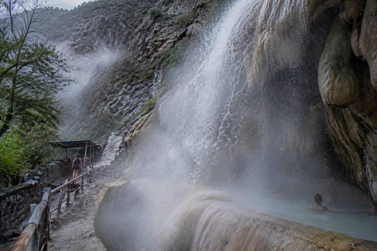 Steaming waterfall cascading from the cave entrance at Grutas de Tolantongo