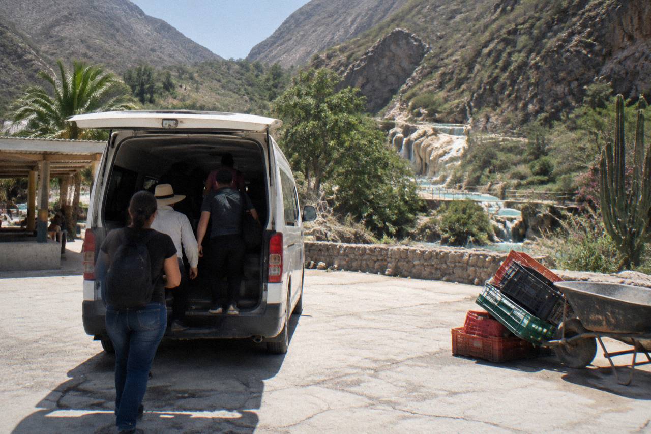 Crowded combi van and passengers boarding at the San Antonio parking lot in Ixmiquilpan