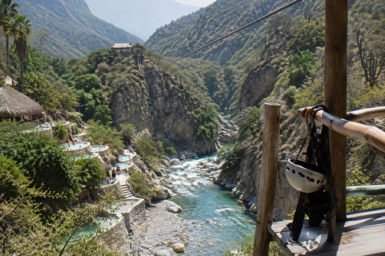Zipline cables crossing high above the green canyon at Grutas de Tolantongo