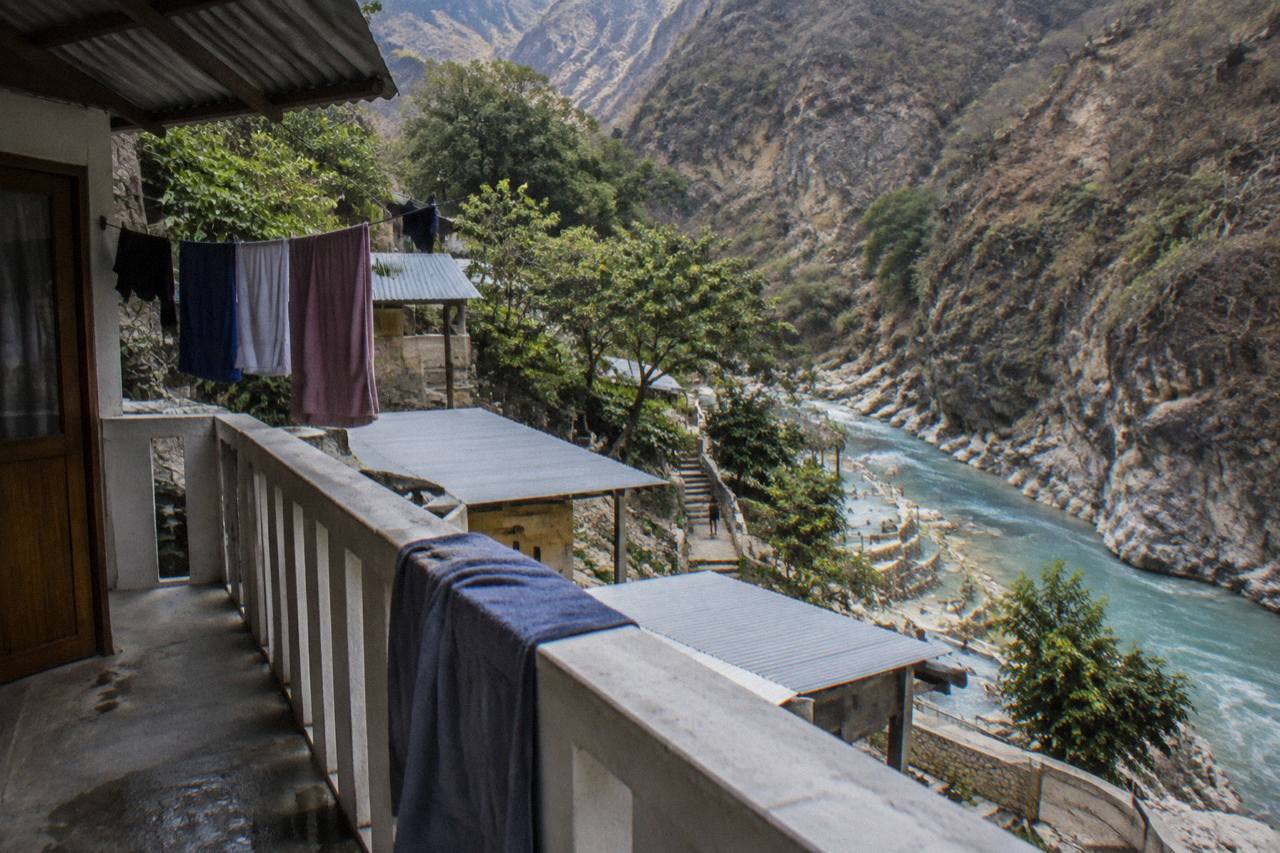 Cabin balconies overlooking the turquoise thermal river inside Tolantongo canyon